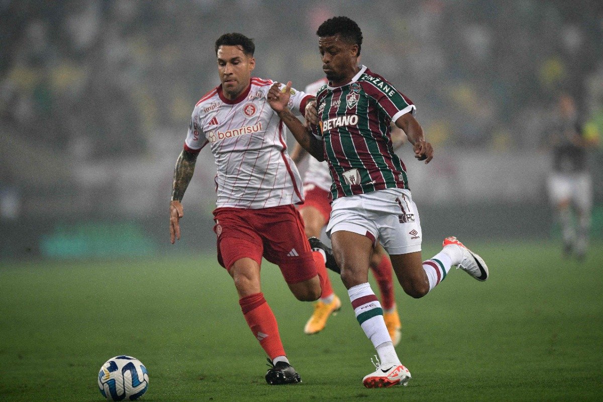 Jogadores de Internacional e Fluminense disputando a bola (foto: CARL DE SOUZA / AFP)