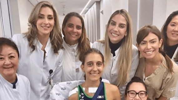 Triatleta Luisa Baptista ao lado da equipe médica no momento de receber alta (foto: Reprodução/Time Brasil)