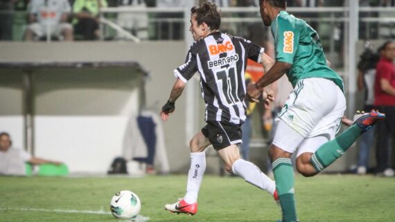 Bernard conduz a bola contra a marcação de jogador em Atlético 3 x 0 Palmeiras em 2012 (foto: Bruno Cantini/Atlético)