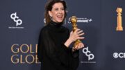 Fernanda Torres sorri e segura o prêmio de melhor atriz no Globo de Ouro (foto: ROBYN BECK/AFP)