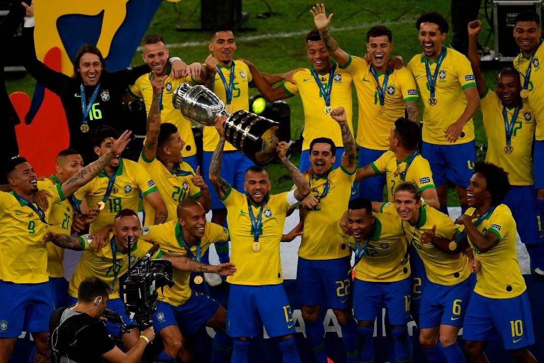 Elenco da Seleção com o troféu da Copa América 2019 (foto: AFP / MAURO PIMENTEL)