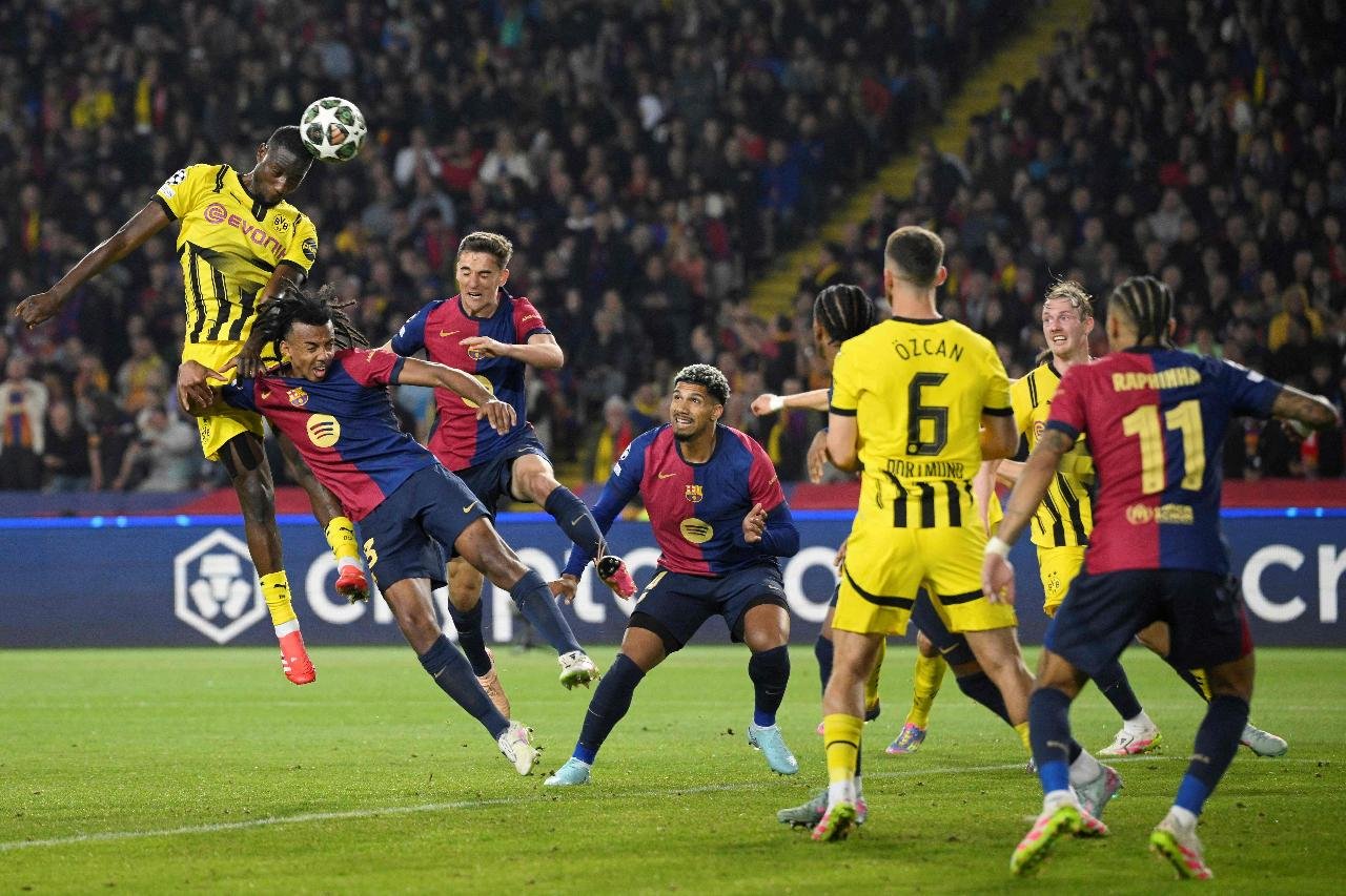 Jogadores do Barcelona e do Borussia dentro da grande área (foto: Josep Lago / AFP)