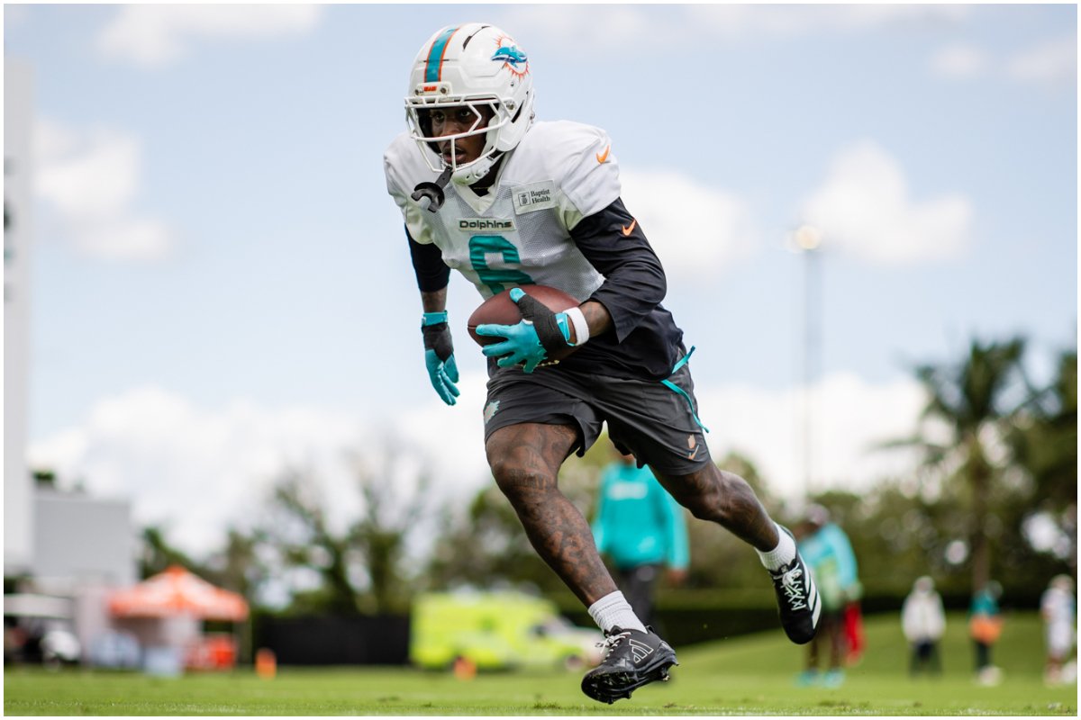 Atleta de futebol americano do Dolphins treinando com bola em campo aberto (foto: Divulgação/Miami Dolphins)