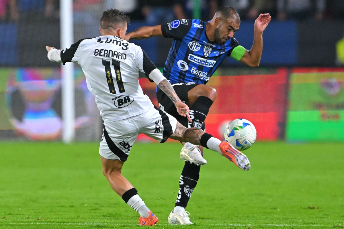 Disputa de bola entre Bernard, do Atlético, e Junior Sornoza, do Independiente del Valle-EQU, em jogo pela Copa Sul-Americana (foto: Rodrigo Buendía/AFP)